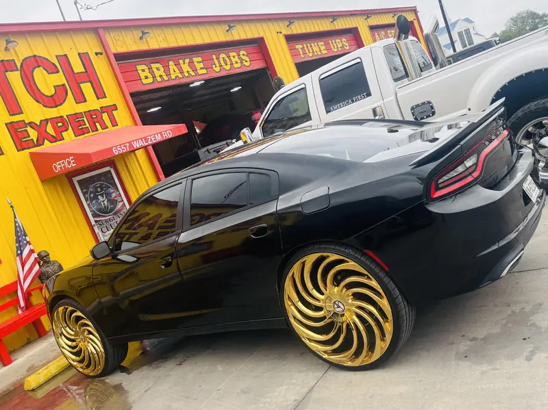Black Dodge Charger with custom gold wheels at Sergeant Clutch
