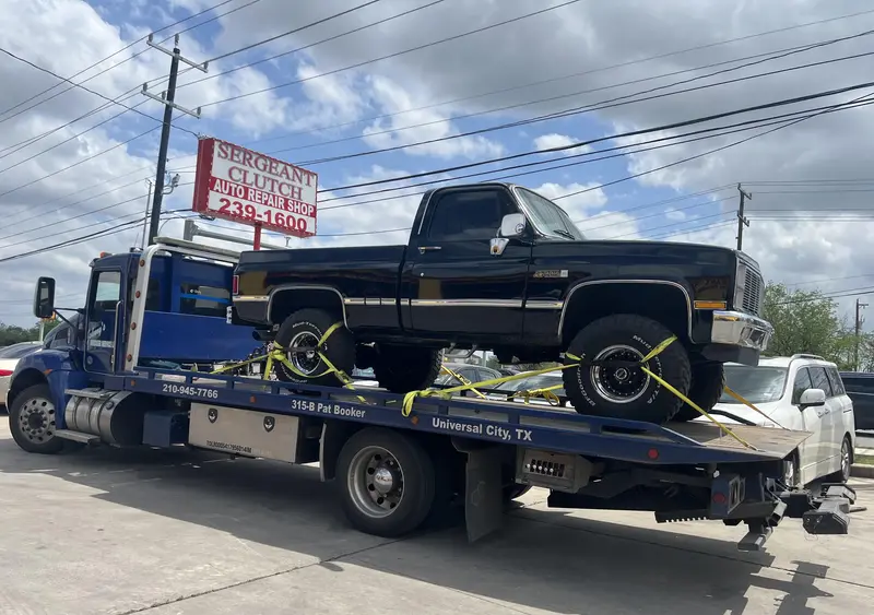 Customer truck arriving on a flatbed tow truck