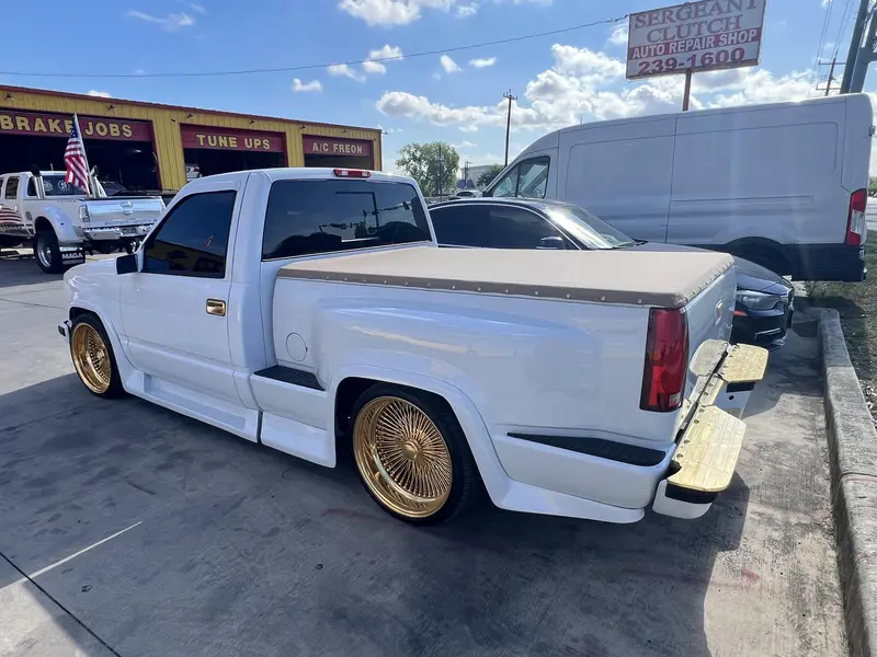 Lowered Chevy truck with gold wheels